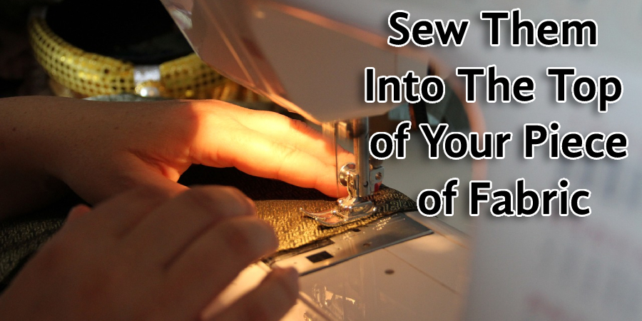 Sew them into the top of your piece of fabric
