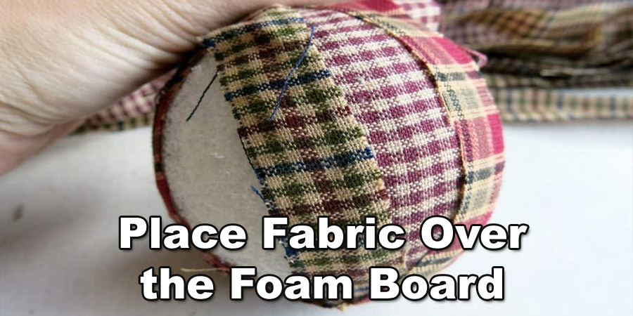 Place the fabric over the foam board
