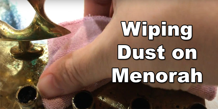 wiping dust on menorah