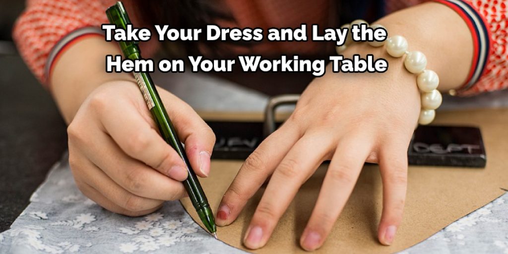 Take Your Dress and Lay the  Hem on Your Working Table