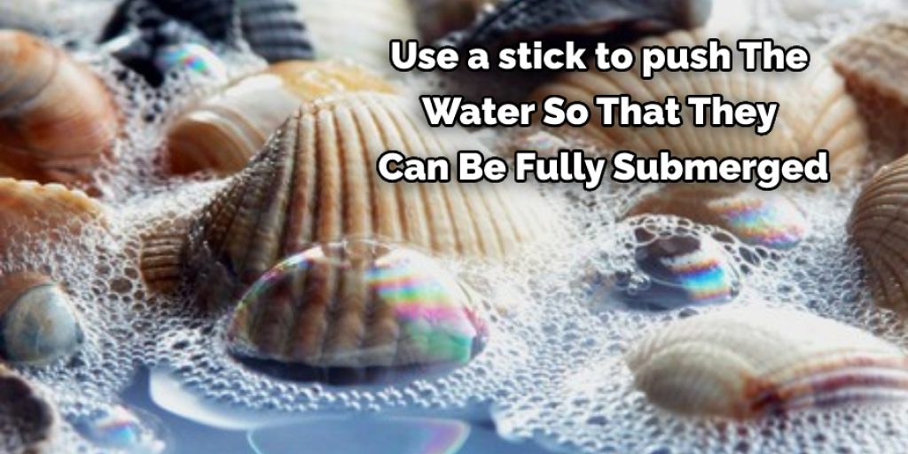 Use a stick to push The Water So That They Can Be Fully Submerged