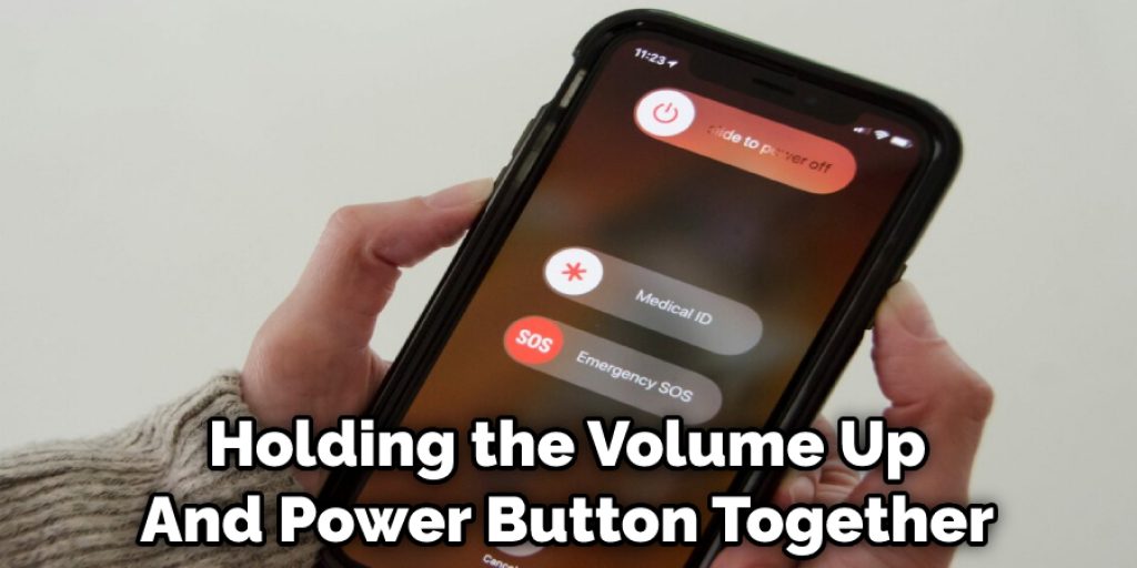 Holding the Volume Up And Power Button Together