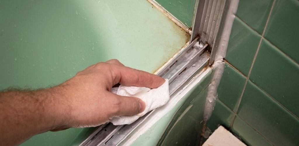 how to clean sliding shower door tracks