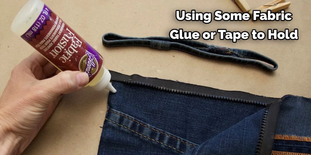 Using Some Fabric  Glue or Tape to Hold 