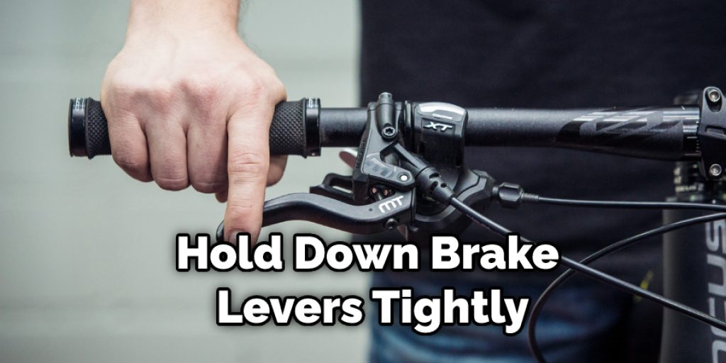 Hold Down Brake Levers Tightly