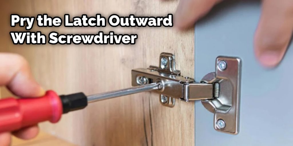 Pry the Latch Outward With Screwdriver