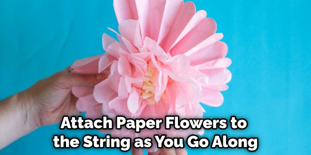 Attach Paper Flowers to the String as You Go Along