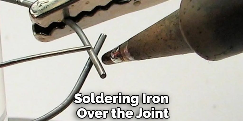 Soldering Iron Over the Joint