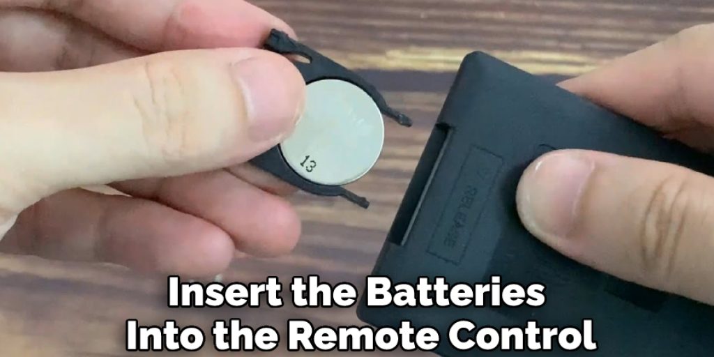 Insert the Batteries Into the Remote Control