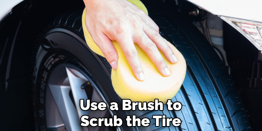 Use a Brush to Scrub the Tire