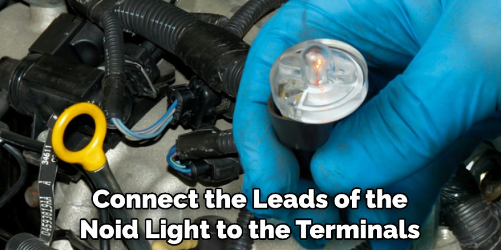 Connect the Leads of the Noid Light to the Terminals