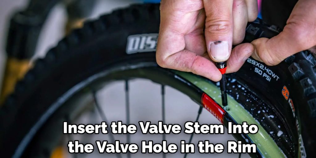 Insert the valve stem into the valve hole in the rim