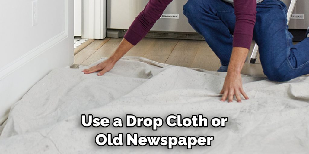 Use a Drop Cloth or Old Newspaper