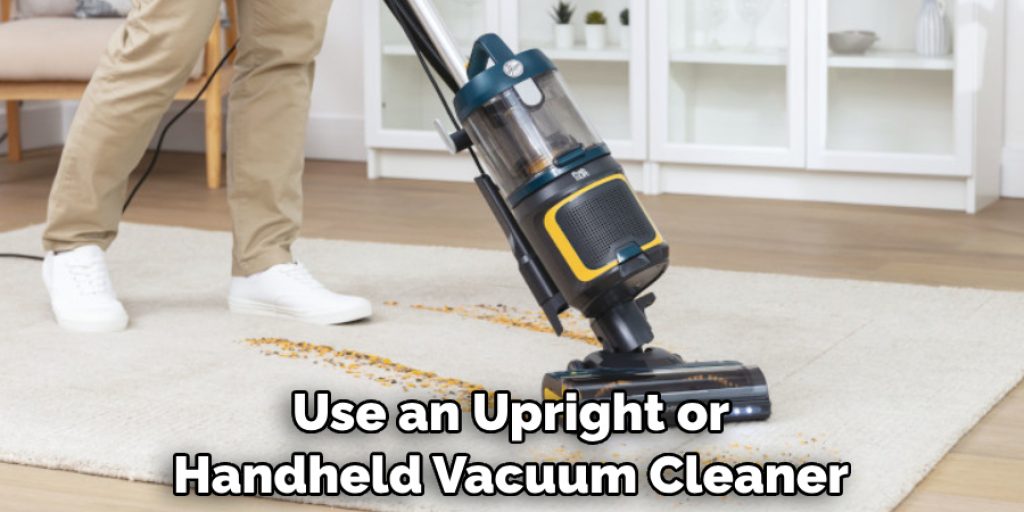 Use an Upright or Handheld Vacuum Cleaner