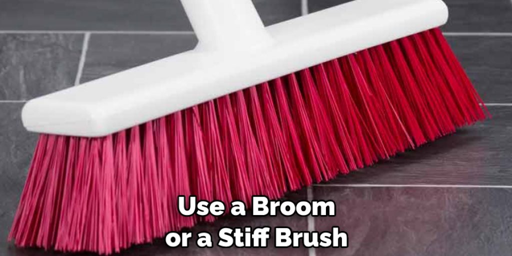 Use a Broom or a Stiff Brush