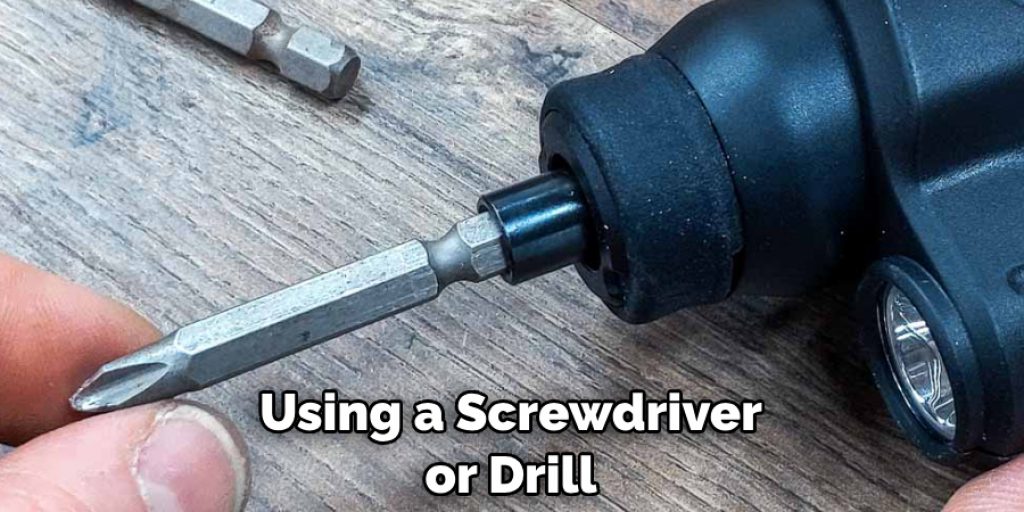Using a screwdriver or drill