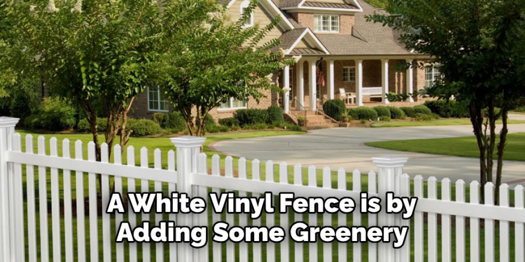 A White Vinyl Fence is by Adding Some Greenery