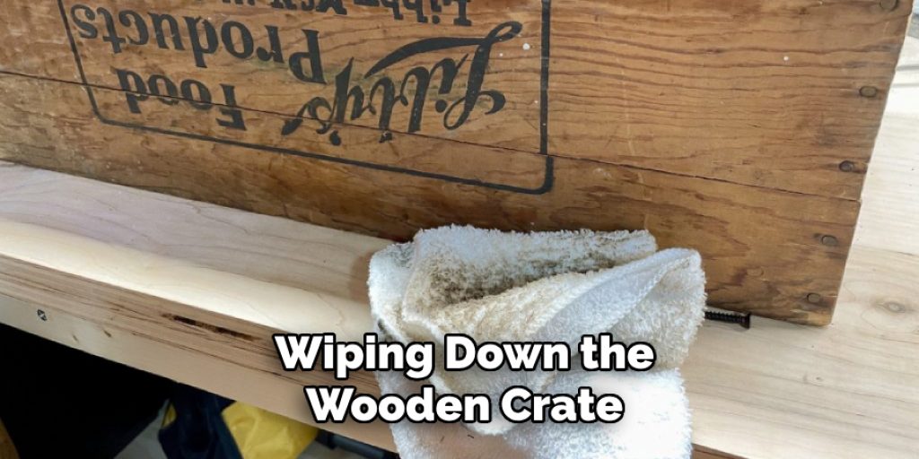 Wiping Down the Wooden Crate