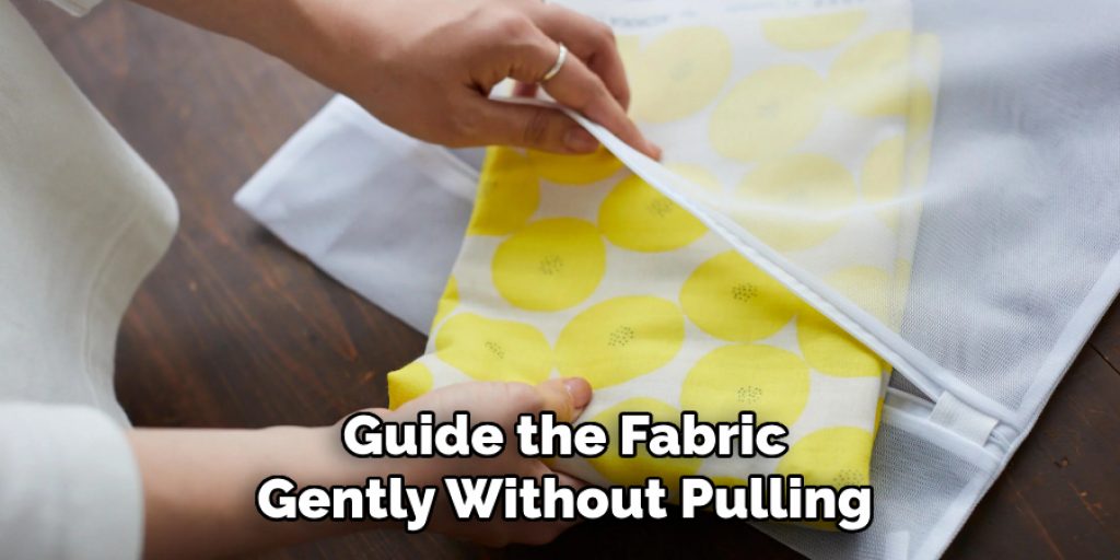 Guide the Fabric
Gently Without Pulling