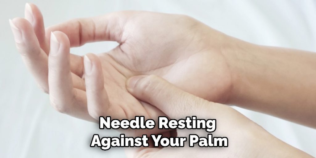 Needle Resting 
Against Your Palm