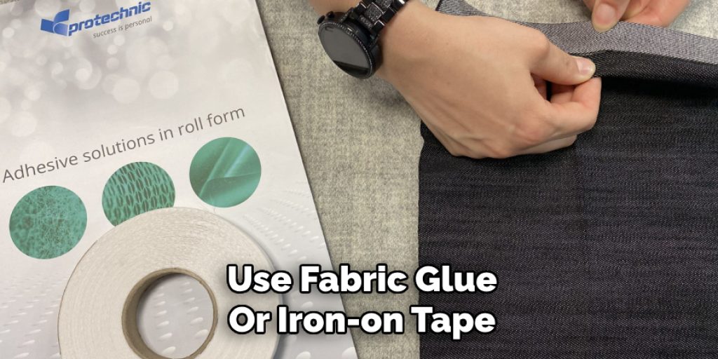 Use Fabric Glue
Or Iron-on Tape