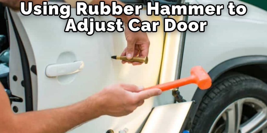 Using Rubber Hammer to Adjust Car Door