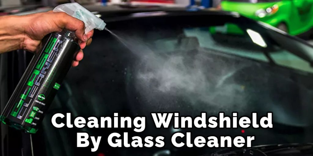 Cleaning Windshield By Glass Cleaner