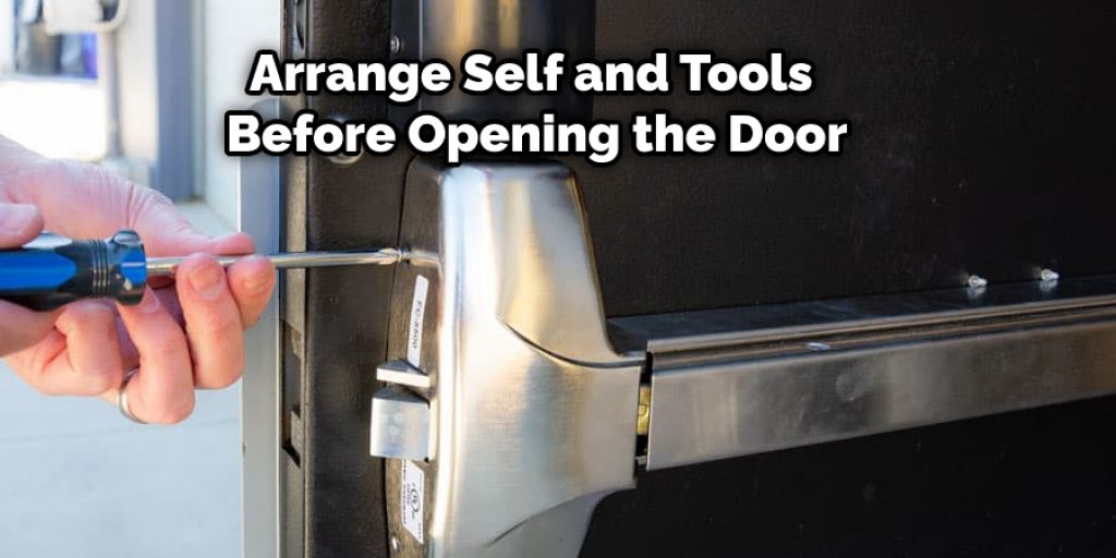 Door can be heavy; arrange self and tools before opening the door.