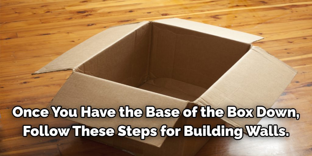 Once you have the base of the box down, follow these steps for building walls. You will make two 2-inch high pieces and one 3-inch high piece (for the door). Place them 4 inches away from each end and side to leave room for a door. Test this by laying it on top of the cardboard base and marking the measurements. These will be the four walls of your whelping box, so you will need to do this twice.
