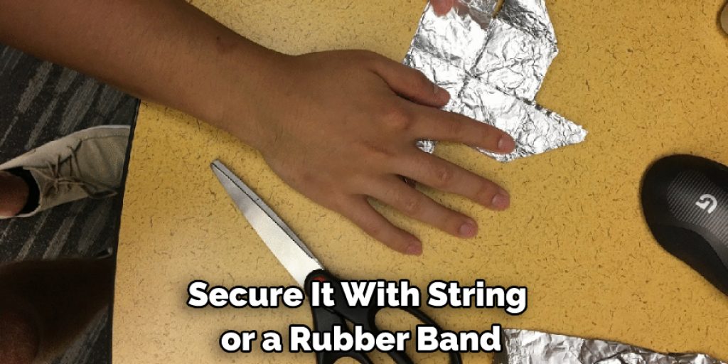  secure it with string or a rubber band.
