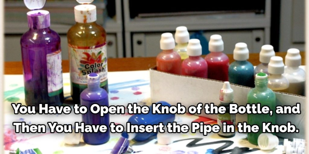 Now you have to open the knob of the bottle, and then you have to insert the pipe in the knob.
