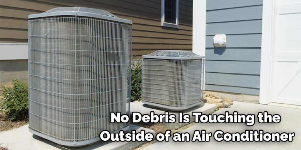 no debris  is touching the outside of an air conditioner.