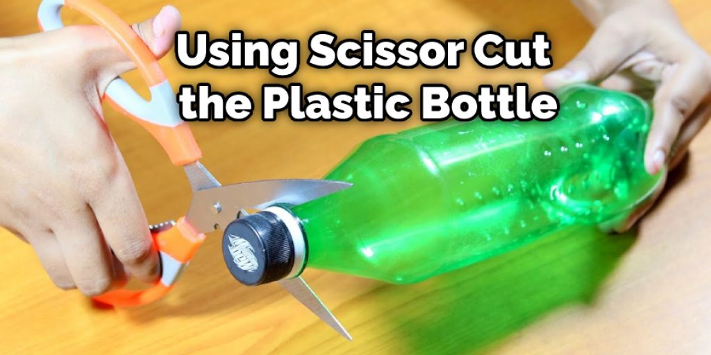 Using Scissor Cut the Plastic Bottle