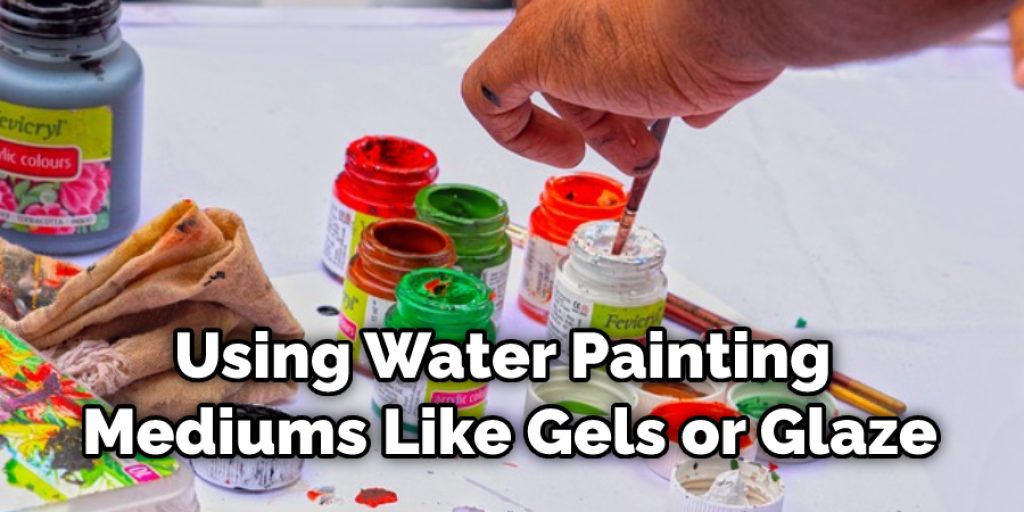 Using water, painting mediums like gels or glaze, alcohol (like vodka), etc. Mixing three parts of water to 1 part of paint is a good ratio.