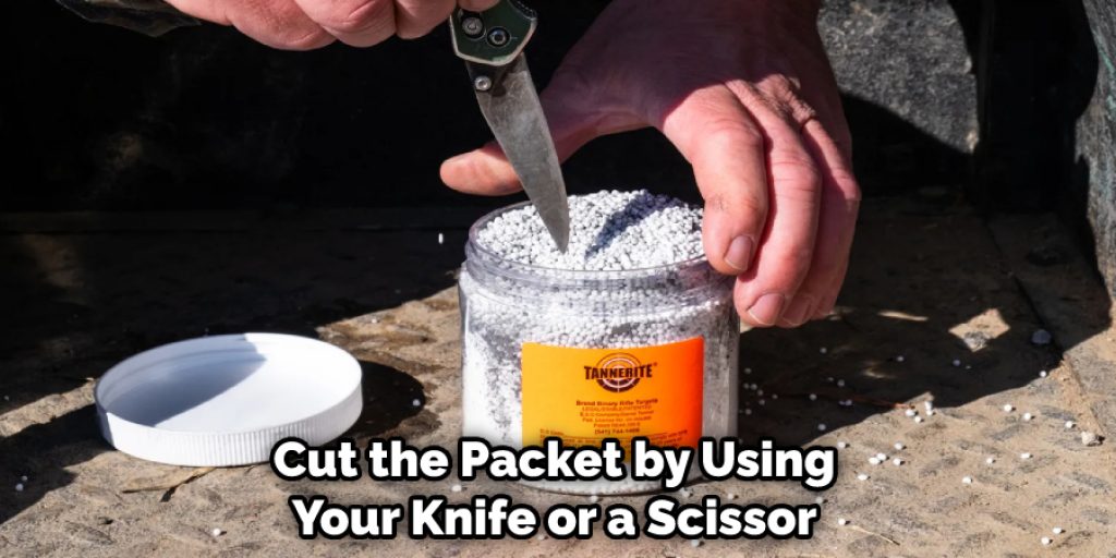 Then take the catalyst and cut the packet by using your knife or a scissor. Okay, then pour it into the mixing container