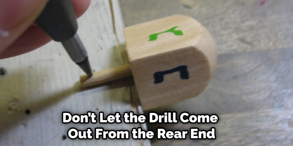 Make sure to do it slowly so that you don’t miss the right place. By the way, don’t let the drill come out from the rear end.