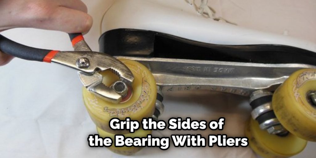 Grip the Sides of the Bearing With Pliers