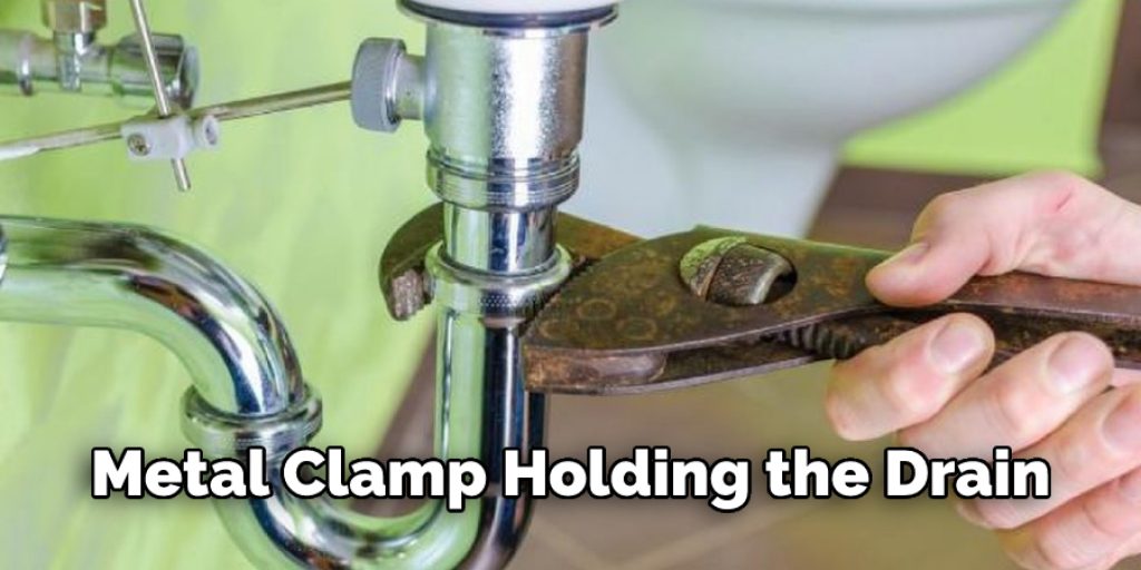 Metal Clamp Holding the Drain