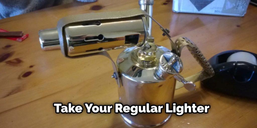 Take your regular lighter, remove its cap and spring and then press the needle through the small hole. Once you complete that, cut the bottom end that contains plastic.
