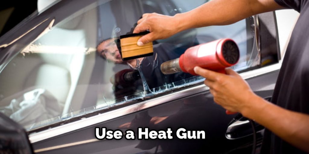 You have a heat gun, this is the best way to remove glue from car glass. 
