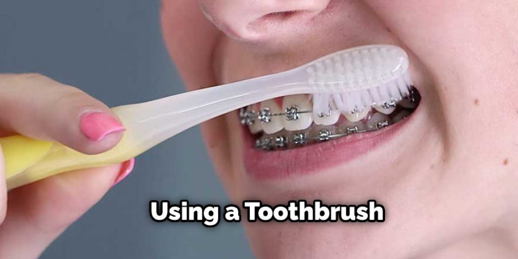 Using a toothbrush is probably the easiest way to remove braces yourself at home without visiting the dentist. 