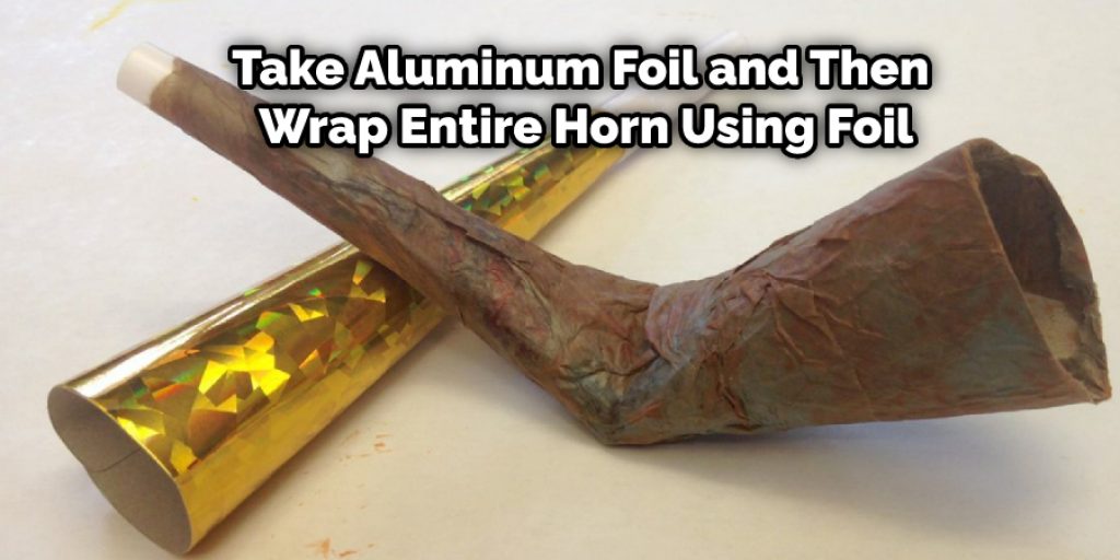 Then you have to take the aluminum foil and then wrap the entire horn using the foil. 