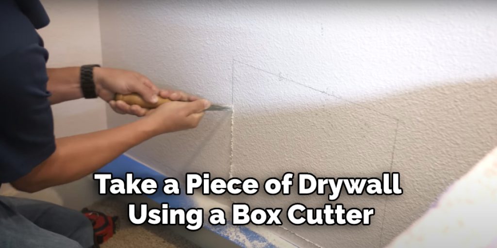 Take a Piece of Drywall Using a Box Cutter