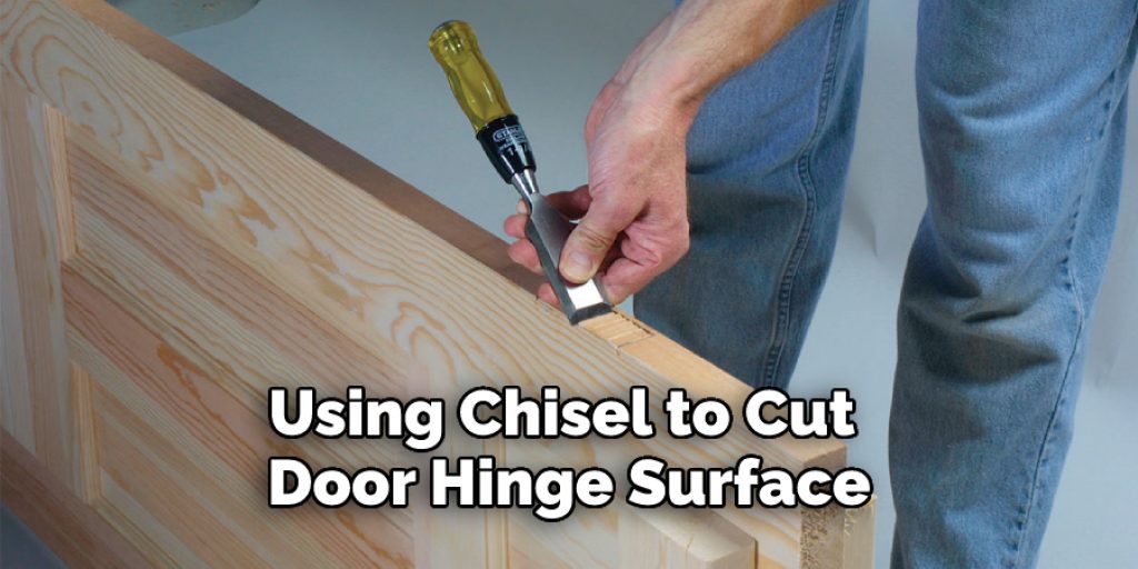 Using Chisel to Cut Door Hinge Surface