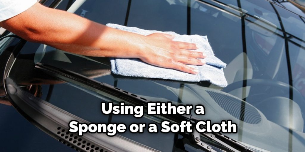 Using Either a Sponge or a Soft Cloth