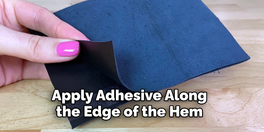 Apply adhesive along the edge of the hem