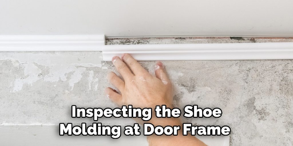 Inspecting the Shoe
Molding at Door Frame 