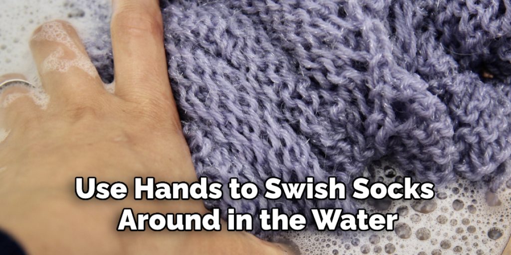 Use Hands to Swish Socks 
Around in the Water