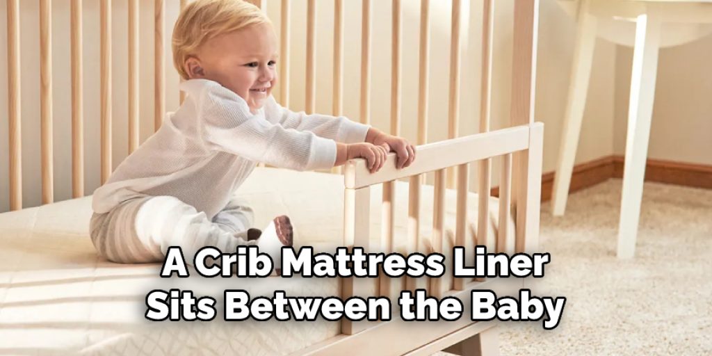 A Crib Mattress Liner Sits Between the Baby