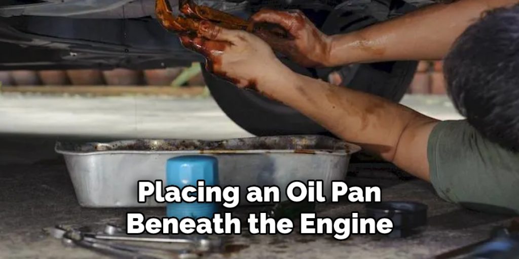 placing an oil pan beneath the engine